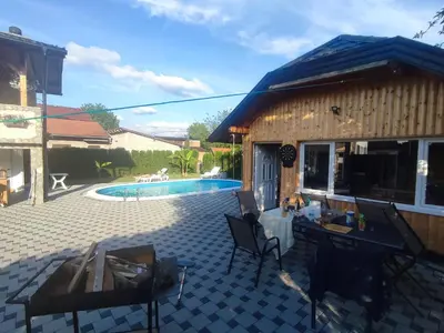 a patio with a house and a swimming pool at Bihać Kralje in Bihać