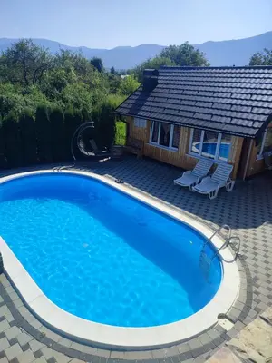 a swimming pool in front of a house at Bihać Kralje in Bihać