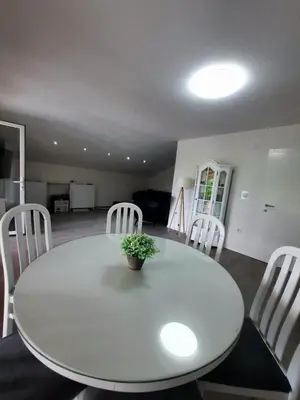 a white dining room table with a plant on it at Bihać Kralje in Bihać