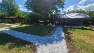 a garden with a walkway in front of a house at Smjestaj na selu KLARA in Staro Selo