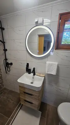 a bathroom with a sink and a mirror at Smjestaj na selu KLARA in Staro Selo