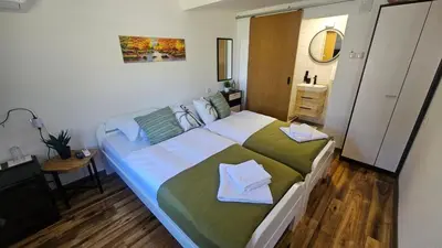 a bedroom with a bed with two towels on it at Smjestaj na selu KLARA in Staro Selo