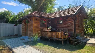 a small wooden cabin with a porch at Smjestaj na selu KLARA in Staro Selo