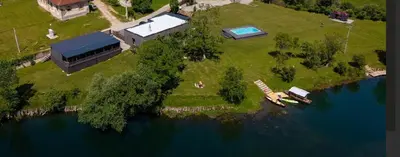 an aerial view of a house on an island in the water at Una Meryland in Kulen Vakuf