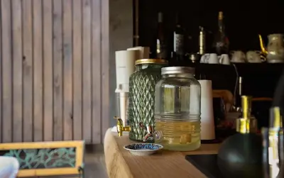 a glass jar sitting on top of a wooden table at Una Meryland in Kulen Vakuf