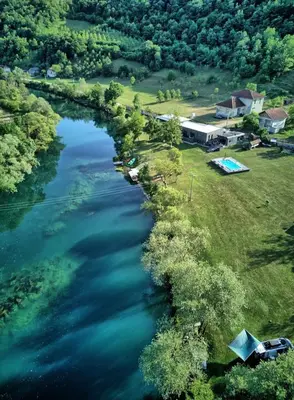 an aerial view of a river with houses and trees at Una Meryland in Kulen Vakuf
