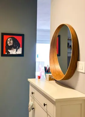 a mirror on top of a dresser in a bathroom at Apartman Lorka in Banja Luka
