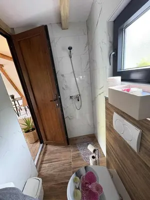 a bathroom with a toilet and a sink and a shower at Vikendica Hamza in Bihać