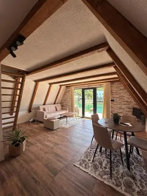 a living room with a table and a couch at Vikendica Hamza in Bihać