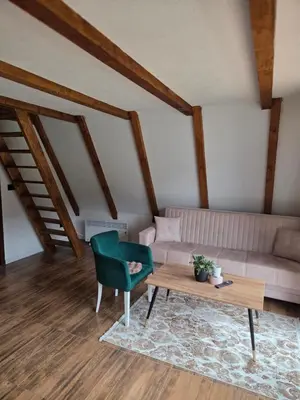 a living room with a couch and a table at Vikendica Hamza in Bihać
