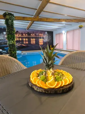 a pineapple on a table in front of a pool at UnaSoul in Bihać