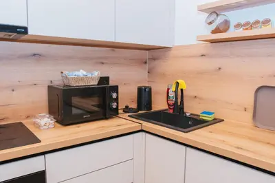 a kitchen counter with a microwave and a sink at UnaSoul in Bihać