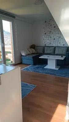 a living room with a couch and a table at Sun-Moon Apartment in Zbilje