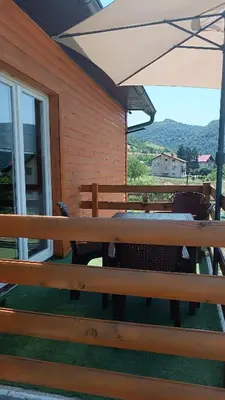 a picnic table and an umbrella on a patio at Sun-Moon Apartment in Zbilje