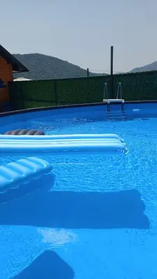a large blue swimming pool with blue water at Sun-Moon Apartment in Zbilje