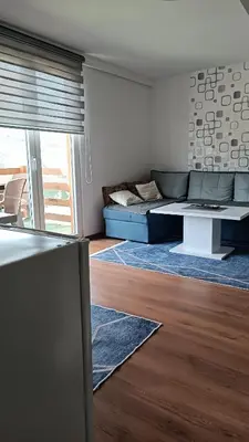 a living room with a couch and a table at Sun-Moon Apartment in Zbilje