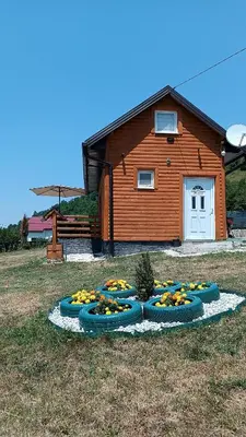 a group of bowls of fruit in front of a house at Sun-Moon Apartment in Zbilje