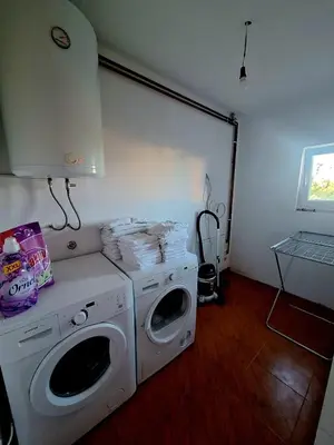 a laundry room with a washing machine and a washer at Villa Forest in Bosanska Gradiška