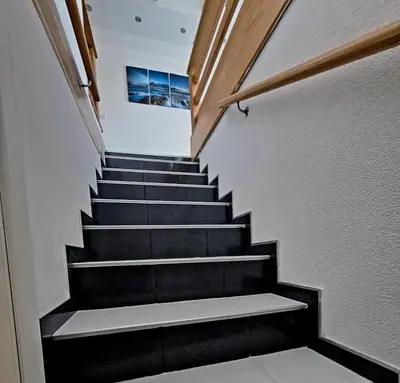 a staircase in a house with black steps at Villa Forest in Bosanska Gradiška