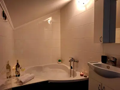 a white bathroom with a tub and a sink at Villa Forest in Bosanska Gradiška
