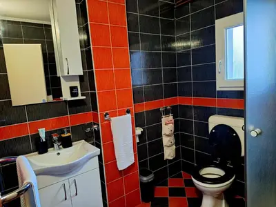 a bathroom with a toilet and a sink at Villa Forest in Bosanska Gradiška