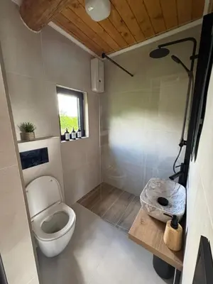 a small bathroom with a toilet and a shower at Brvnara Tribalija