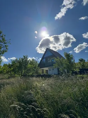 a house sitting on top of a grass field at Vikendica Malekin in Ripci
