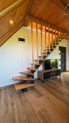 a living room with a staircase and a tv at Vikendica Malekin in Ripci