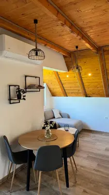 a room with a table and chairs and a couch at Vikendica Malekin in Ripci
