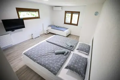 a bedroom with a bed and a tv in it at Villa Ella in Bihać