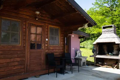 a log cabin with a fireplace and a patio at Villa Ella in Bihać