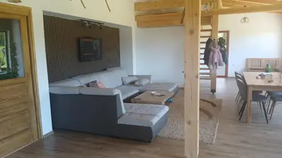 a living room with a couch and a table at Planinska kuća Bajni