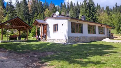 a small house in the middle of a field at Planinska kuća Bajni