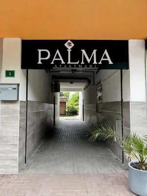 a entrance to a building with a sign on it at Sobe PALMA in Sanski most