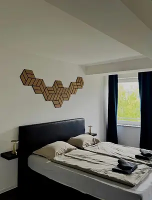 a bedroom with a bed with a heart on the wall at Sobe PALMA in Sanski most