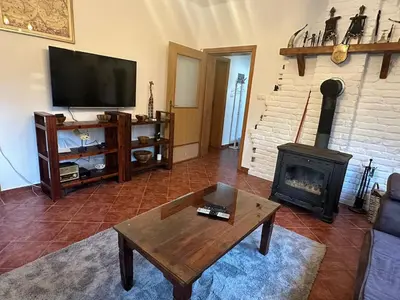 a living room with a television and a fireplace at Cottage on Una in Bihać