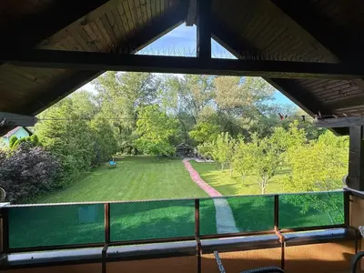 a view of a yard from a window at Cottage on Una in Bihać