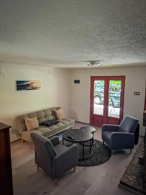 a living room with a couch and chairs and a table at Vikendica Stella in Bihać