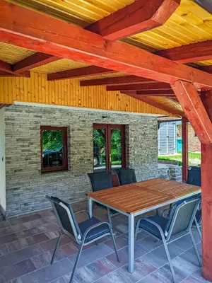 a wooden table and chairs on a patio at Vikendica Stella in Bihać
