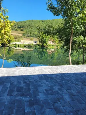 a view of a lake from a patio at Apartman A&A in Ivišovo Greblje
