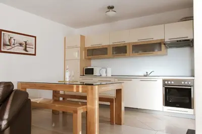 a kitchen with a wooden table in a room at Kuća za odmor KUNA in Kupres