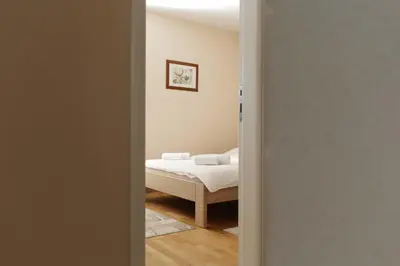a door leading to a bedroom with a bed at Kuća za odmor KUNA in Kupres