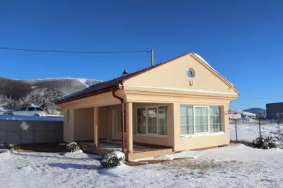 a small house with snow on the ground at Kuća za odmor KUNA in Kupres