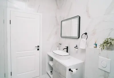a white bathroom with a sink and a mirror at Villa Maison de luxe in Laktaši