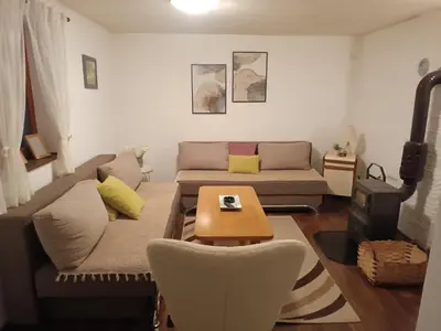 a living room with a couch and a table at Vlasic Relax Location in Vlasic
