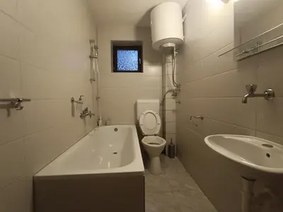 a bathroom with a tub and a toilet and a sink at Vlasic Relax Location in Vlasic