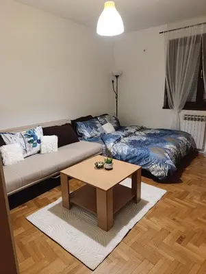 a living room with a couch and a coffee table at 7th Sky in Banja Luka