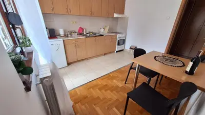 a small kitchen with a table and a dining room at 7th Sky in Banja Luka