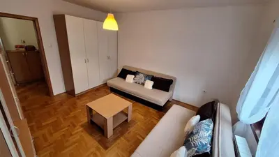 a living room with a couch and a table at 7th Sky in Banja Luka