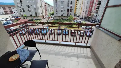 a balcony with chairs and a view of a city at 7th Sky in Banja Luka